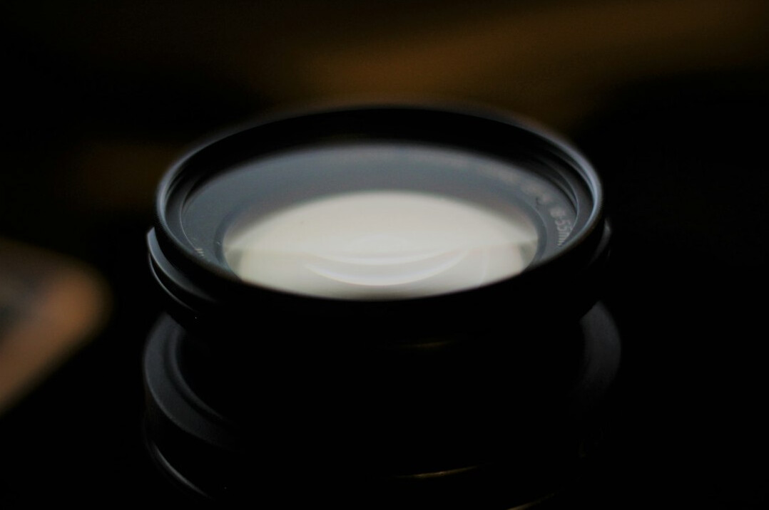 Close-up of a camera lens with reflections